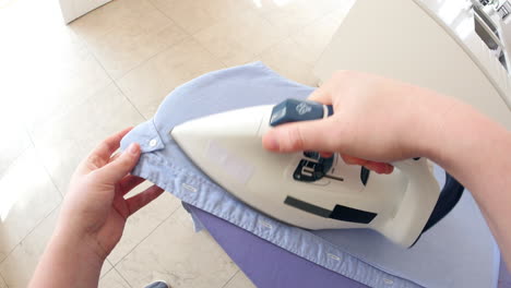 point of view of man ironing shirt