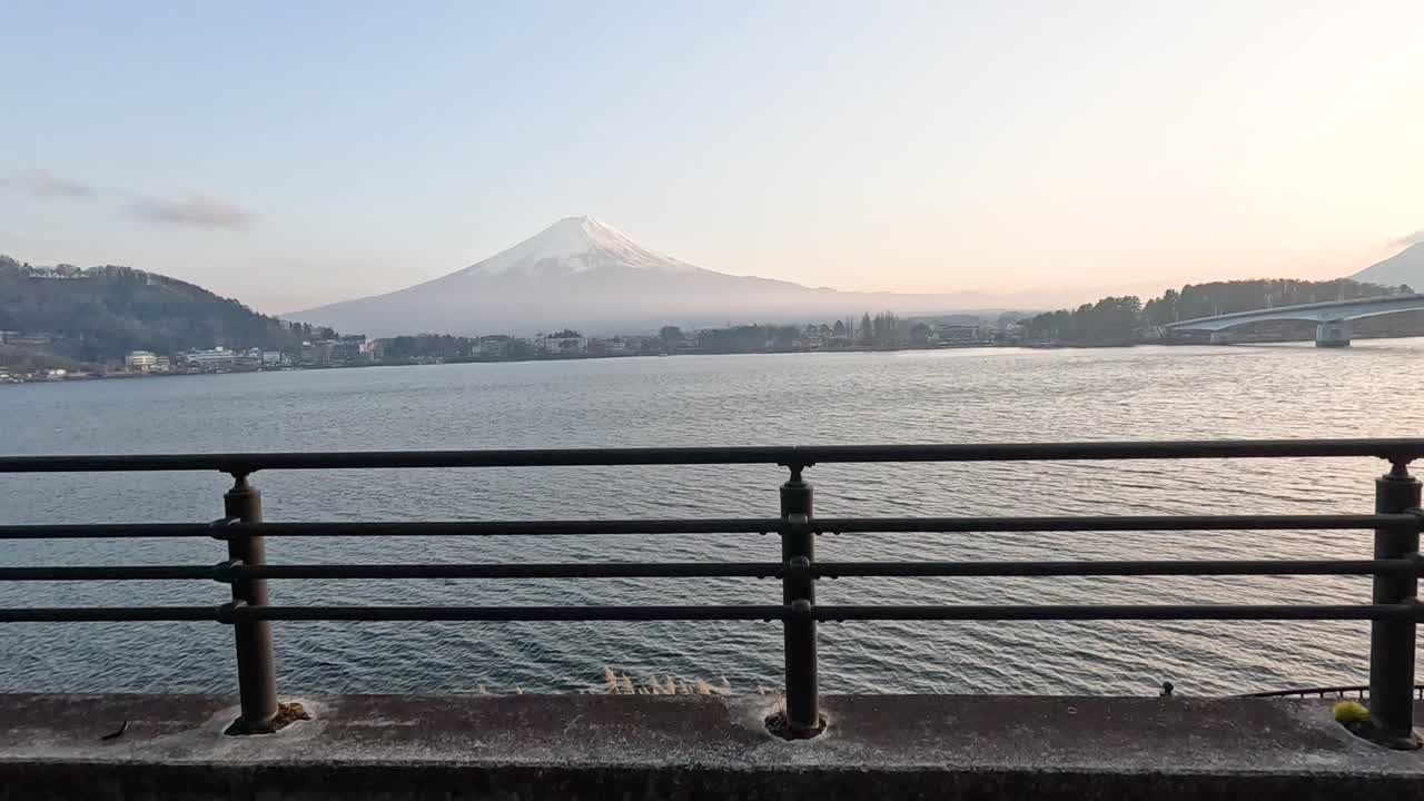 A tranquil 20-second video capturing Mount Fuji across Lake Kawaguchi at dawn, with soft lighting and gentle camera movement