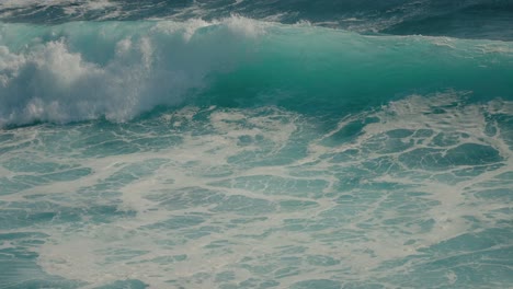 large turquoise ocean wave crashing in super slow motion