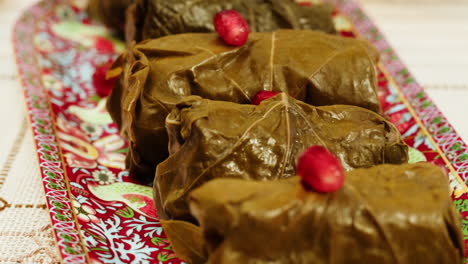 delicious stuffed grape leaves (dolmas) on a decorated tray
