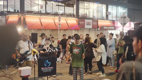 street performers entertain crowd at night