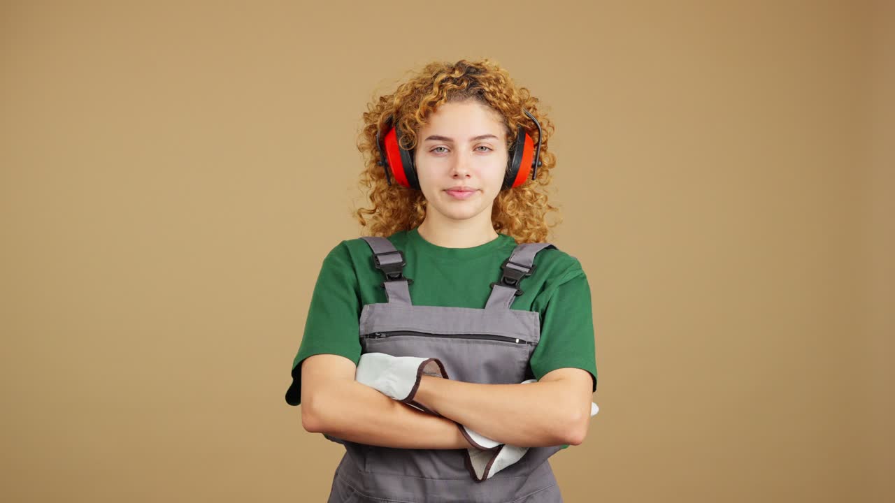 Portrait of a Young Woman in Work Attire and Ear Protection