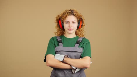 portrait of a young woman in work attire and ear protection