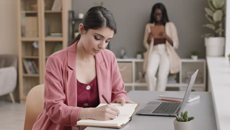 woman taking notes in the office