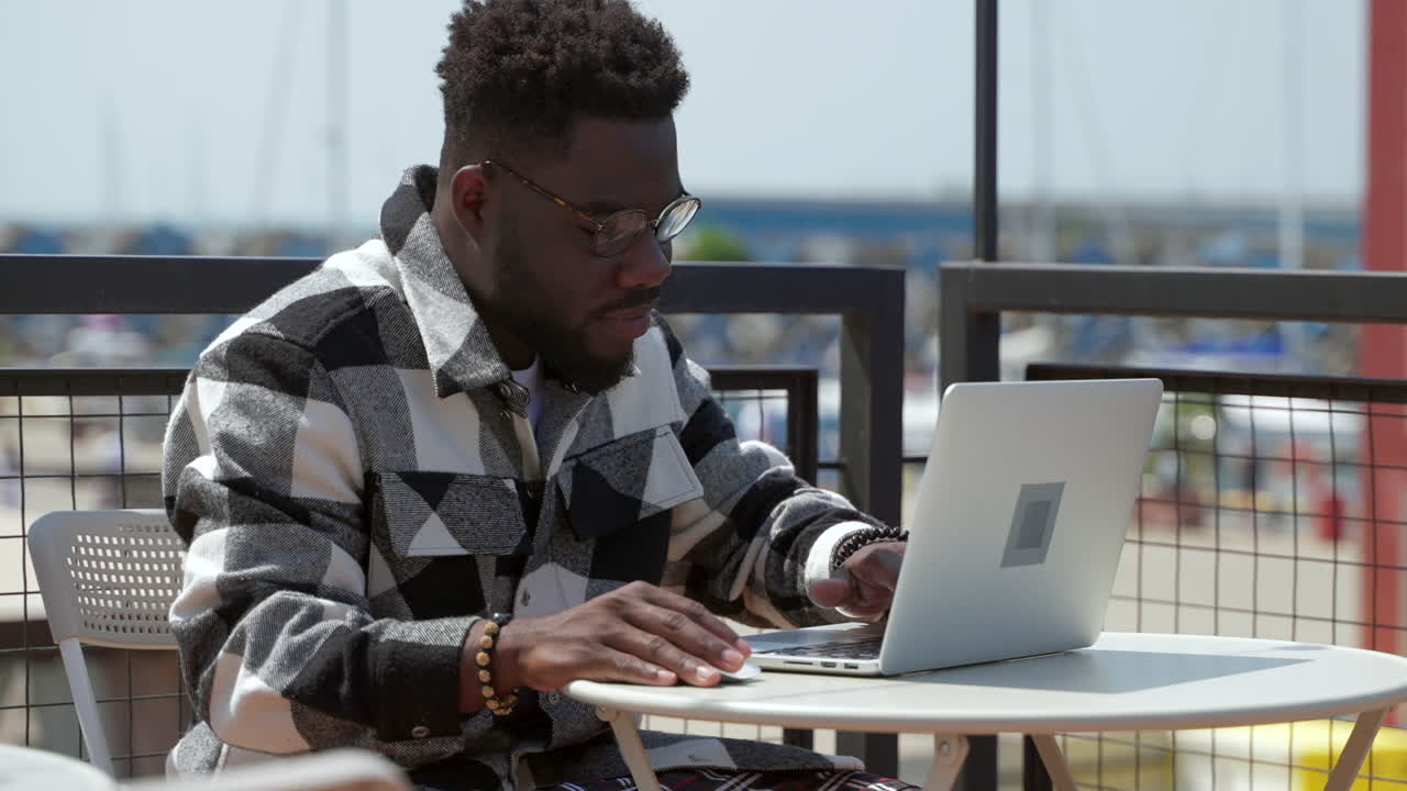 Man working on a laptop outdoors