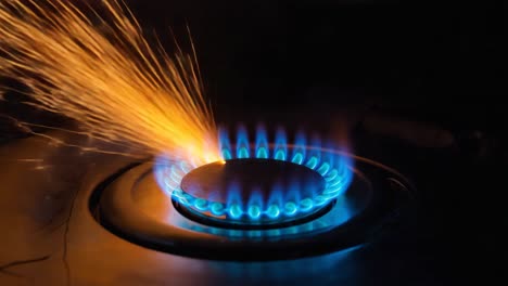 gas burner with blue flames and intense sparks