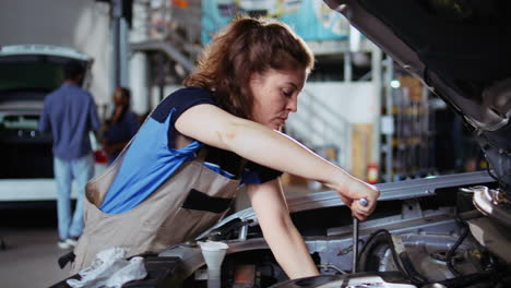 garage worker tightens car bolts