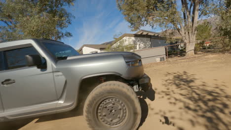 fpv circling shot of a tactical police suv driving through the desert