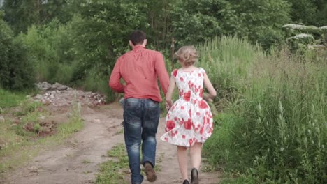 couple running through countryside