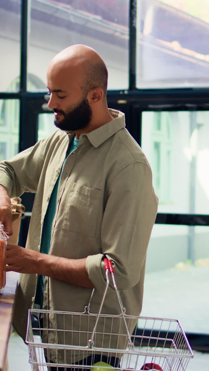 Vertical video Young client shops at supermarket