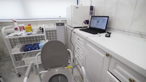 medical exam room with specialized toilet