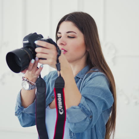 professional photographer woman is taking pictures of the young sexy bride in the studio. wedding female photographer with camera takes pictures of a beautiful bride.