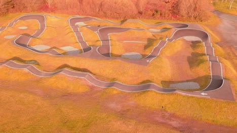 EBoarder-riding-around-pump-track-with-drone-taking-the-shot