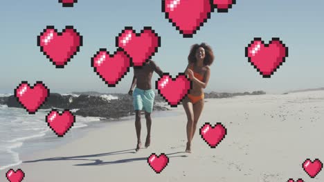 animación de iconos digitales de corazón sobre una pareja corriendo y tomados de la mano en la playa