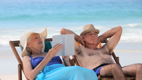 Elderly-couple-relaxing-on-beach-chairs