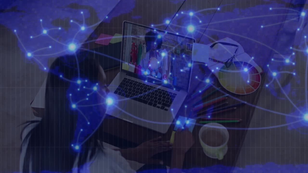 designer clicking laptop and jotting color notes in design call while network overlay animating