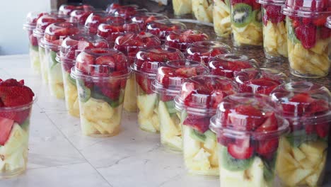 fresh fruit salad cups for sale at a market