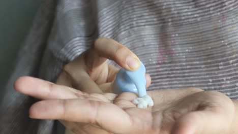 woman applying lotion to her hand