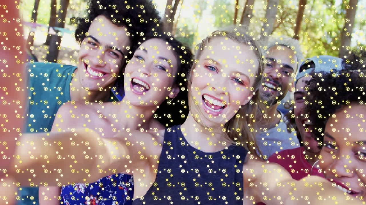 In sunny forest, friends taking selfie with sparkling animation overlay