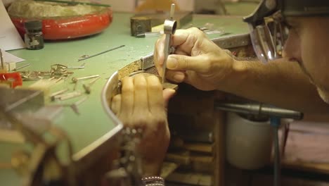 italian goldsmith at work building an engagement or a wedding ring