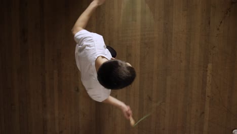 active guy doing jumping rope exercise at home - closeup top shot