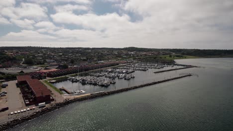 flyover beautiful marina in the danish countryside, sailboats, yachts and boats - dolly in shot