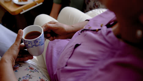 close-up of active senior woman drinking coffee at nursing home 4k