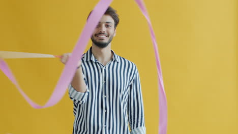 man twirling ribbons