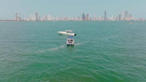 aerial drone shot of a boat going to help a stranded boat in the ocean, colombia, cartagena