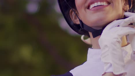 Female-jockey-prepares-for-race,-closeup-on-face