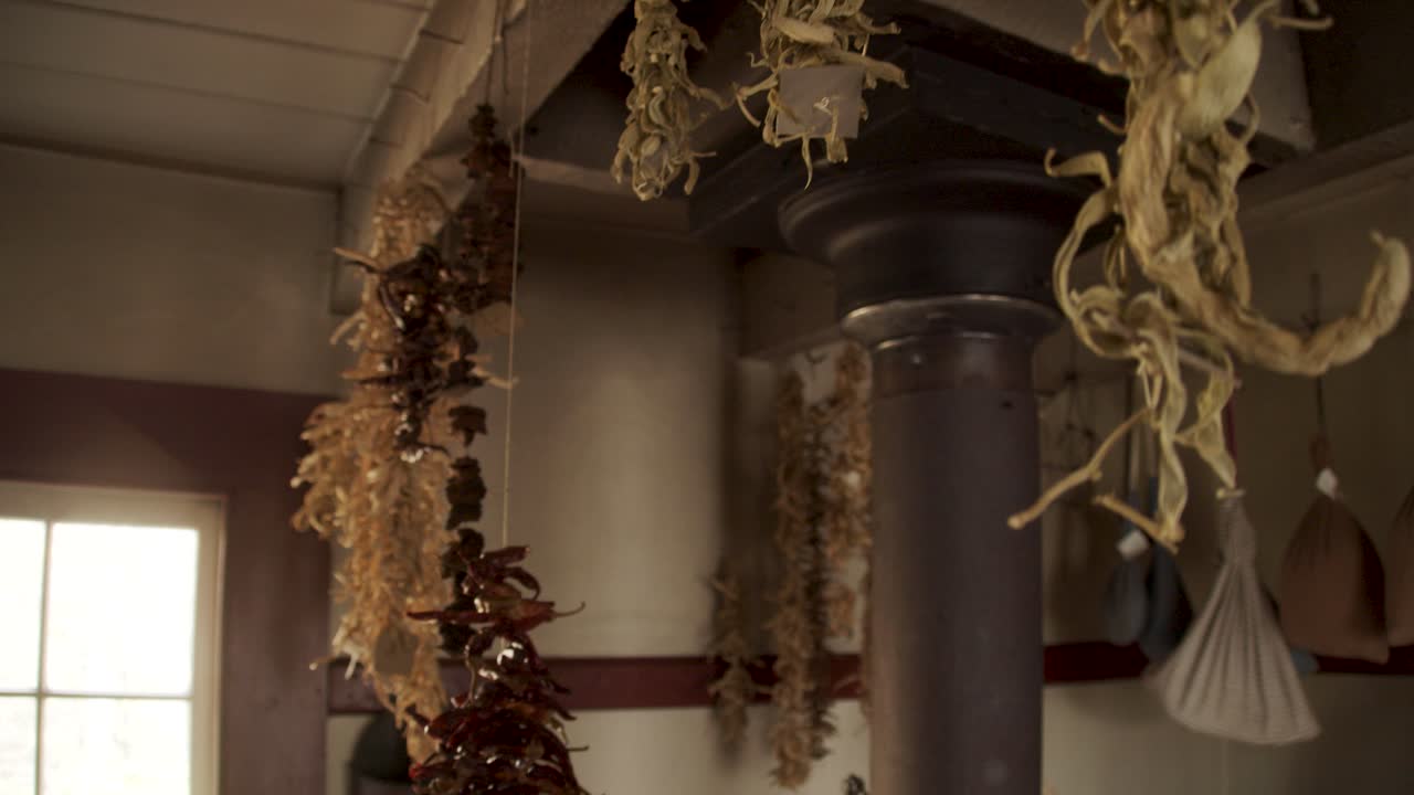 Herbs tied up and handing out to drying in an old fashioned kitchen