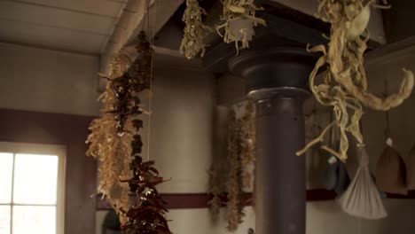 herbs tied up and handing out to drying in an old fashioned kitchen