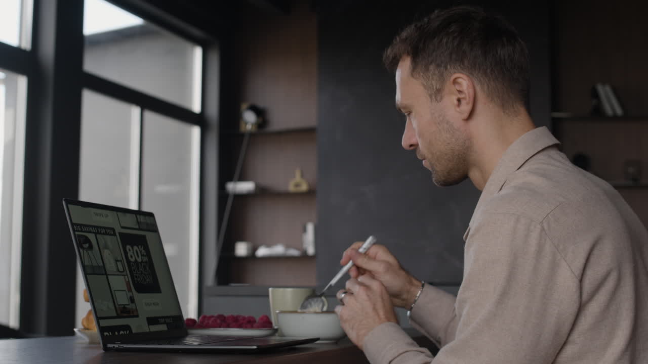 Man shopping online during breakfast