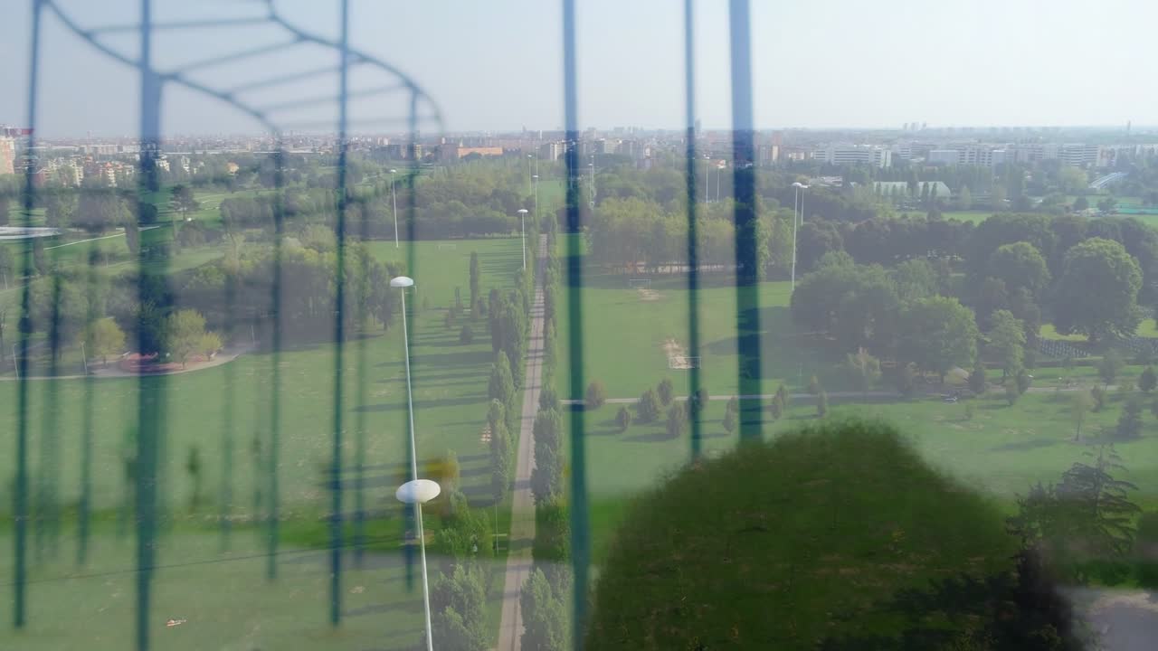 Adult woman leaning on glass and lowering head, starting overlay revealing park walkway for design