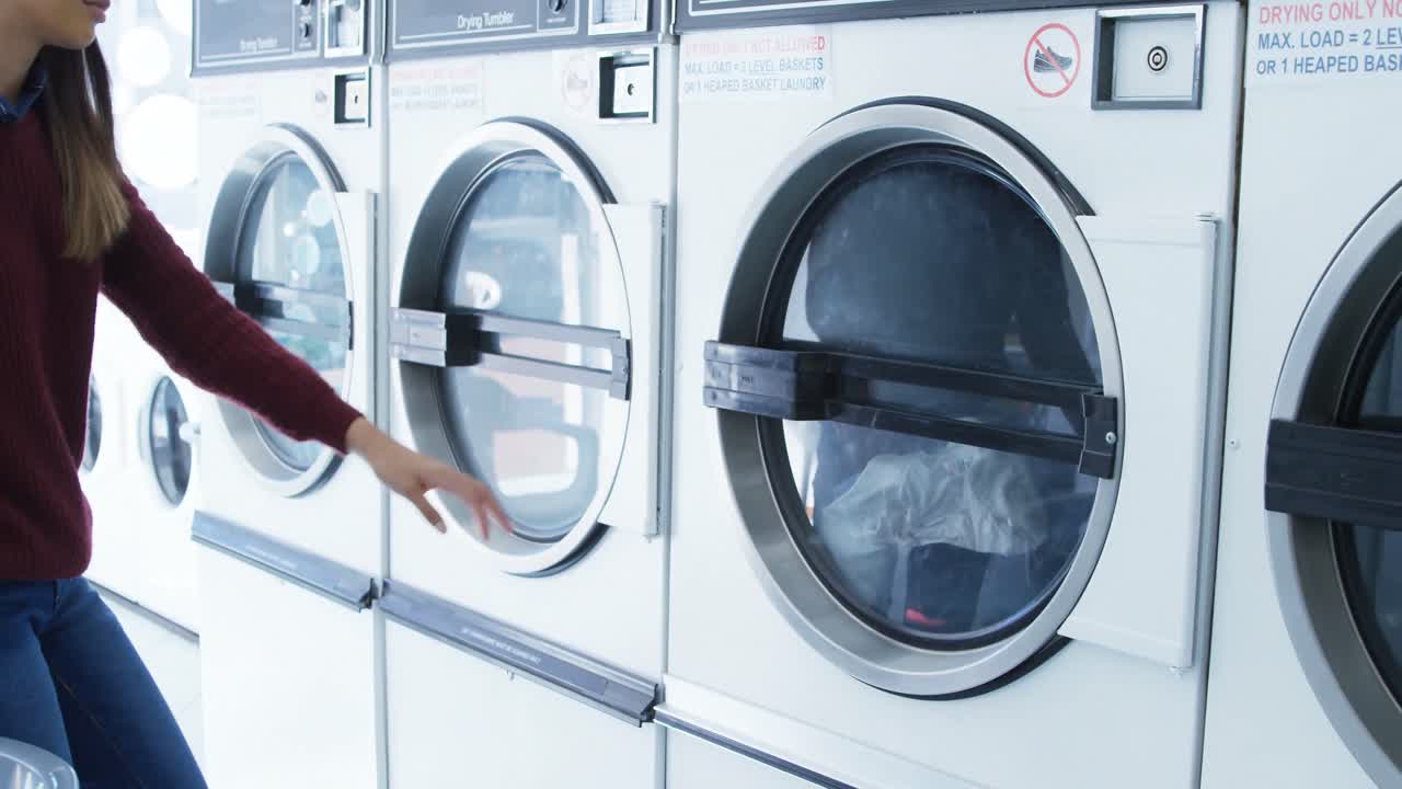 Woman removing clothes from washing machine 4k