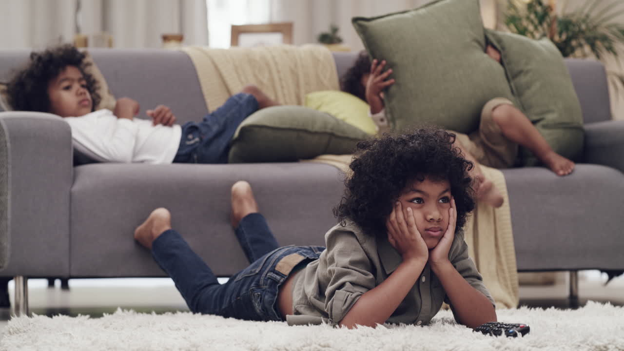 Siblings Relaxing on Couch and Floor
