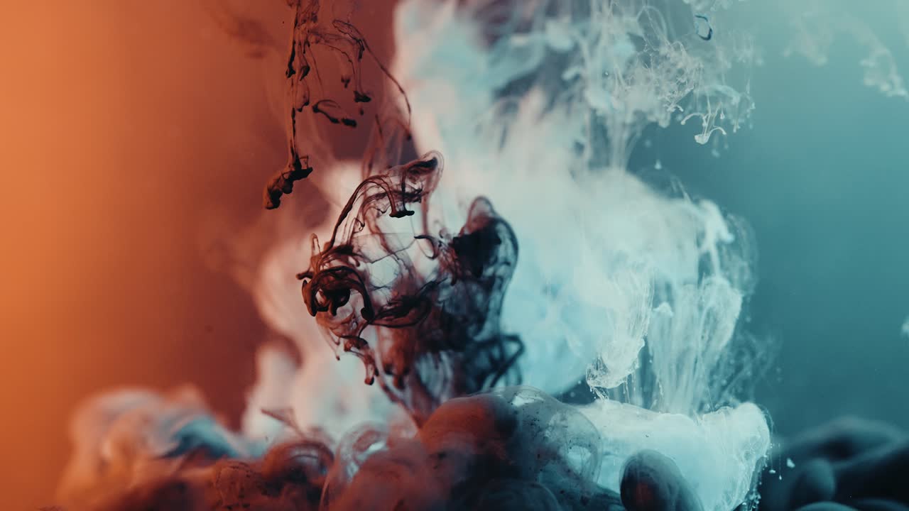 Colorful Liquid Sinking In Water. macro, slow motion