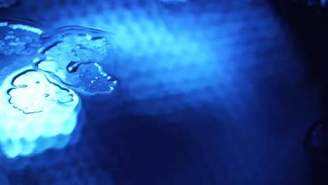 shooting of rainy drops on blue glass background