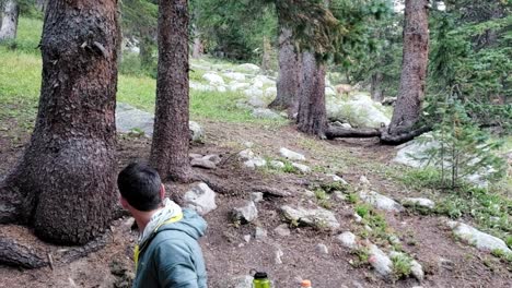 Guy-watching-deer-in-forest-in-Colorado