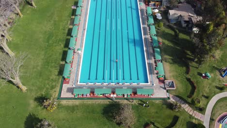 drone 4k video of an olympic size outdoor swimming pool