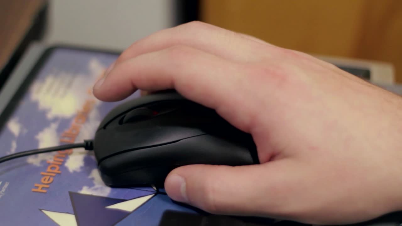 Hand on mouse moving, using a computer