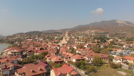 aerial view of the svetitskhoveli cathedral, located in the city of mtskheta, georgia, with the camera moving forward to the cathedral