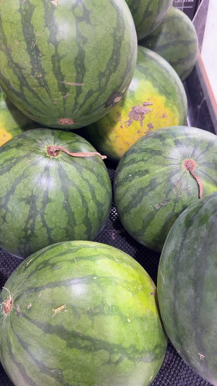 Pile de pastèques vertes fraîches sur un marché