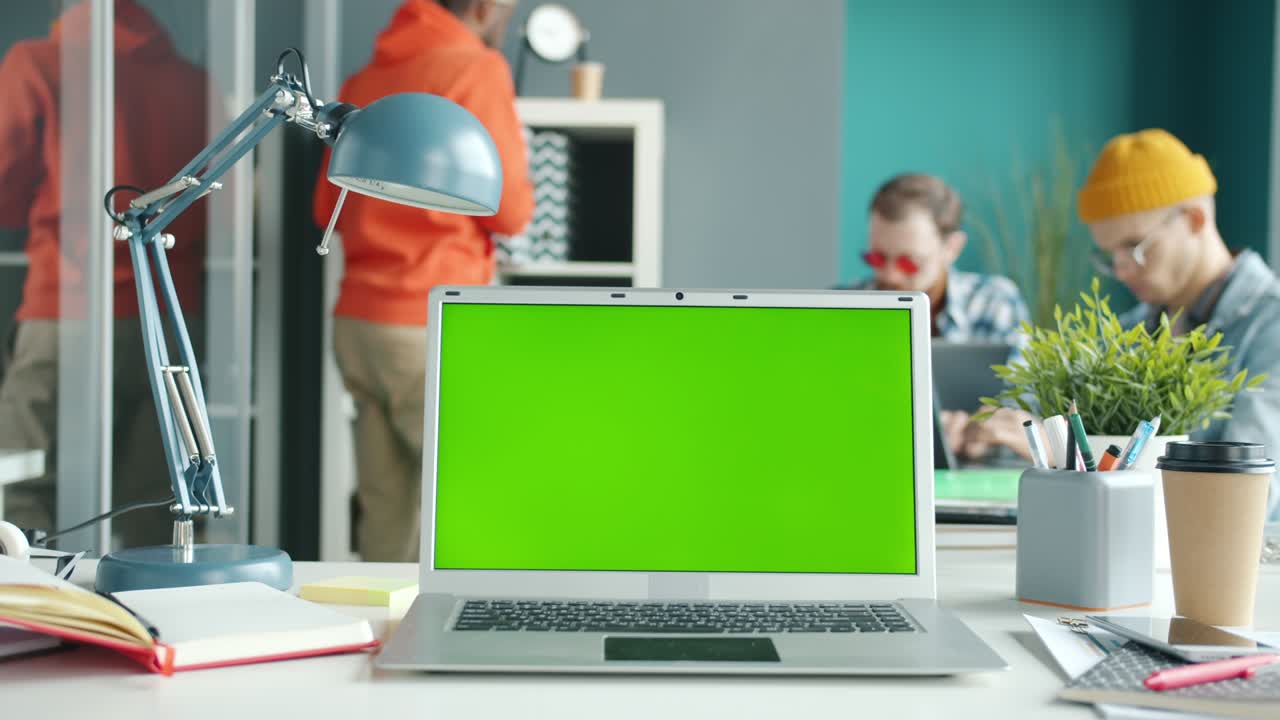 Slow motion of modern laptop with chroma key green screen on office desk