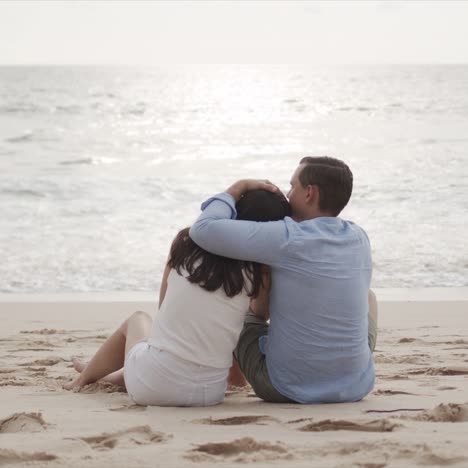 young lovers on honeymoon hugging at beautiful sea beach