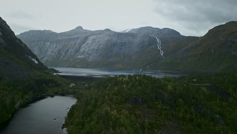drone flies over a mountain lake in norway
