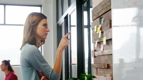 business executive looking at sticky notes