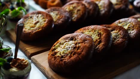 Brown-baked-savory-buns-on-wooden-board-celebration-table,-Czechia