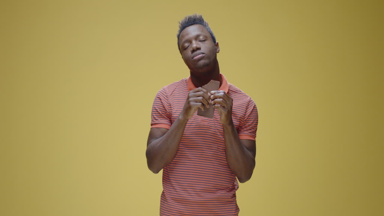 A man enjoying a chocolate bar