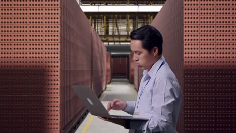 Factory worker using laptop